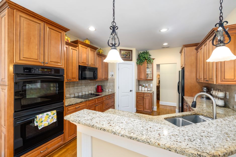 Spacious kitchen featuring wooden cabinets, granite countertops, and modern appliances.